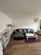 Wohnzimmer - Sonnige modernisierte 2 Zimmer Wohnung in NU-Offenhausen mit Münsterblick